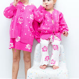Girls in matching pink hibiscus tie-up cardi sets - Dad Dressed Me Tropical Trip
