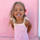Pink Just Keep Swimming sun dress with cream tie straps and scalloped neckline