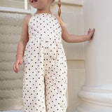 Close up of the Daisy Dot Jumpsuit bodice and gathered waist in cream with brown spots