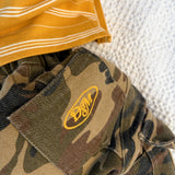 Close up of the Dad Dressed Me logo patch on the Garden Explorer Cargos in cotton camo