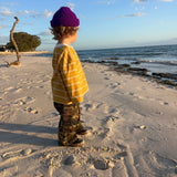 Child on the beach at sunset in the Garden Explorer Cargos and Last Light Long Sleeve