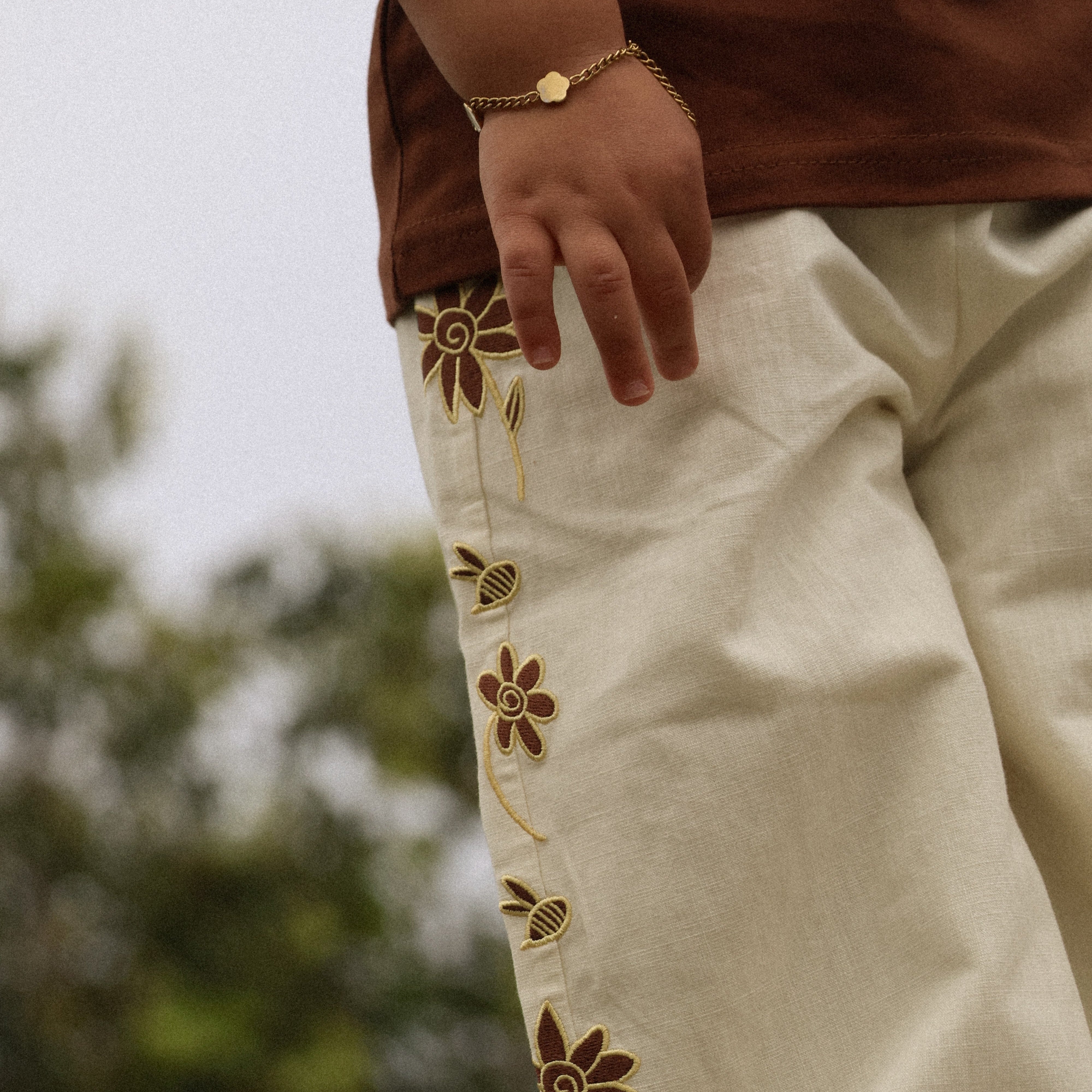 Let's Pick Flowers Pants in cream cotton linen, gold and brown embroidered flower and bee detail down the side