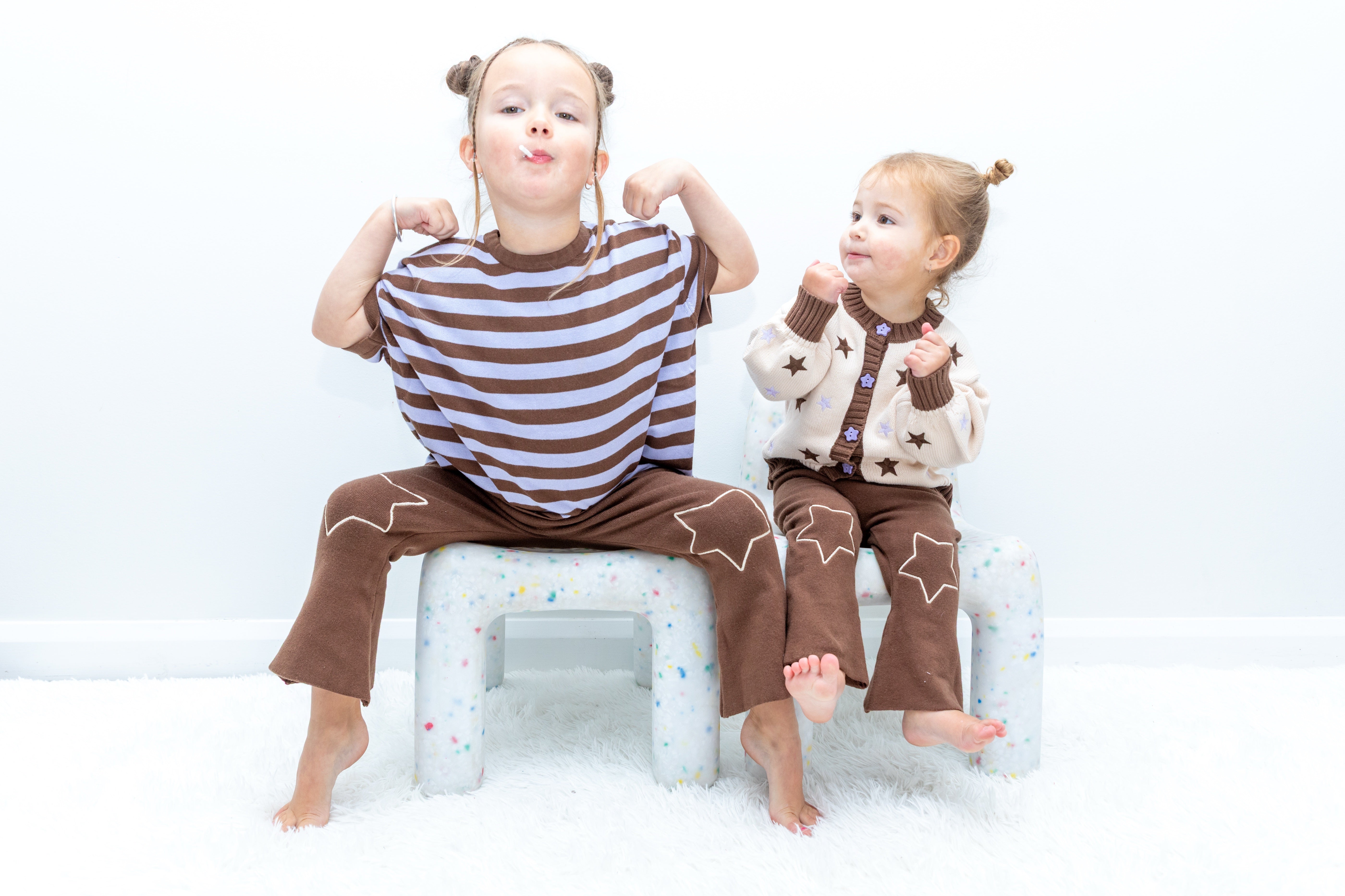Two children wearing the Starry Flare Pant with Star Gazer tops