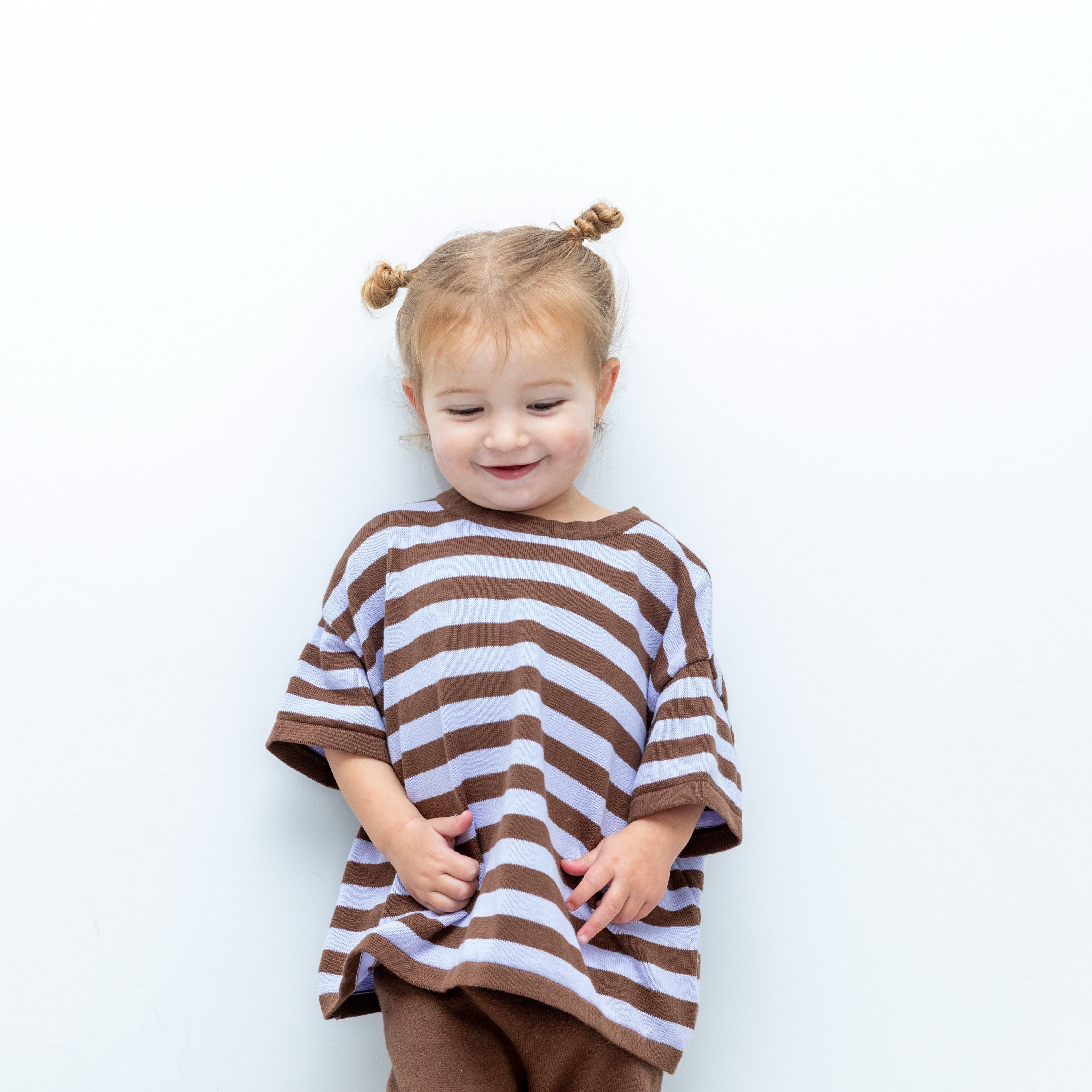 Toddler wearing the Cosmic Tee in brown and lavender stripes